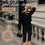 Une femme élégante portant un pantalon capri au style moderne dans une rue ensoleillée.